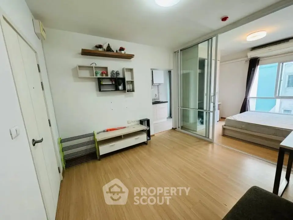 Modern studio apartment with open layout and wooden flooring