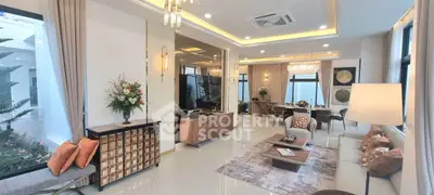 Luxurious open-plan living room with elegant decor and ample natural light.