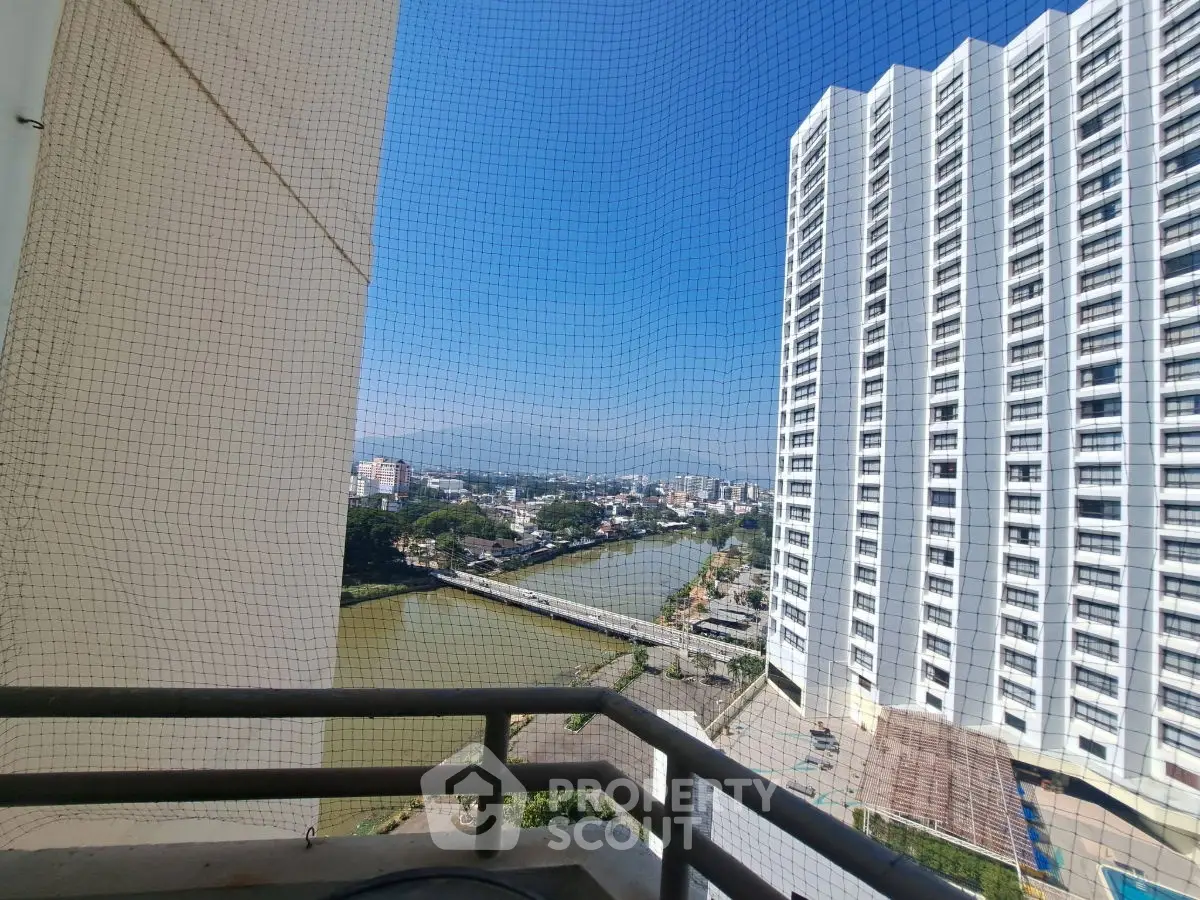 Stunning river view from high-rise balcony with cityscape backdrop