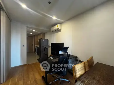 Modern study room with sleek desk, ergonomic chair, and air conditioning in a stylish apartment.