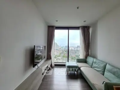 Modern living room with large window and city view, featuring sleek furniture and minimalist design.