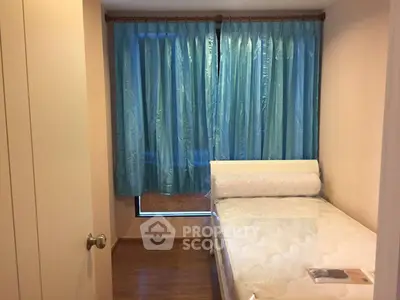 Cozy bedroom with blue curtains and a comfortable bed in a modern apartment.