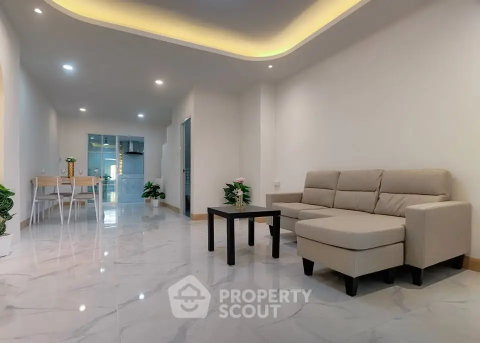 Spacious modern living room with elegant lighting and marble flooring