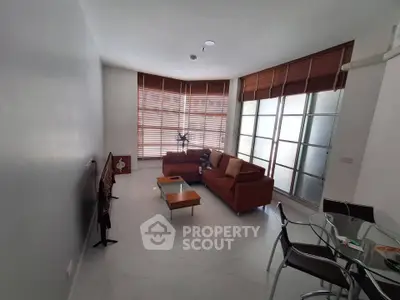 Spacious modern living room with stylish furniture and large windows for natural light.
