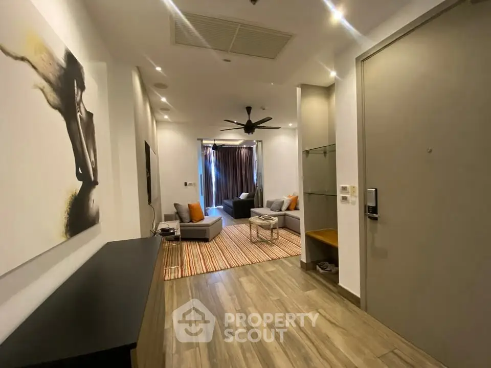 Modern living room with stylish decor and open layout, featuring contemporary furniture and elegant lighting.