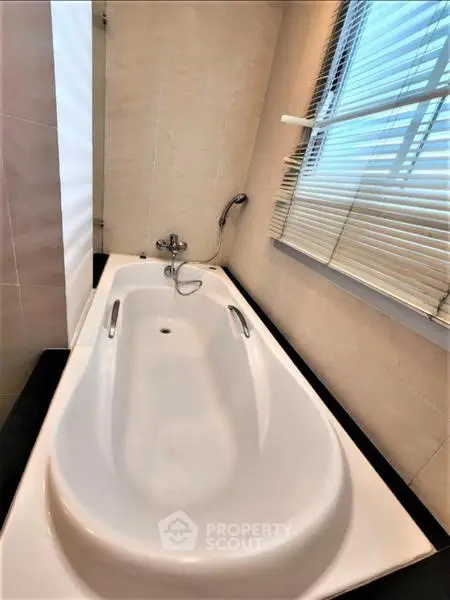 Luxurious bathroom with modern bathtub and stylish blinds