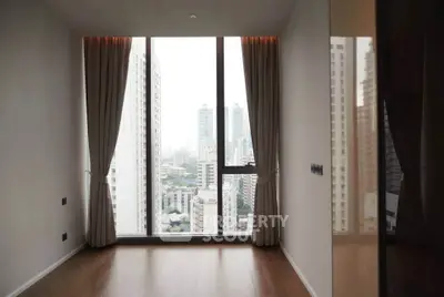Spacious high-rise apartment with floor-to-ceiling windows offering stunning city views.