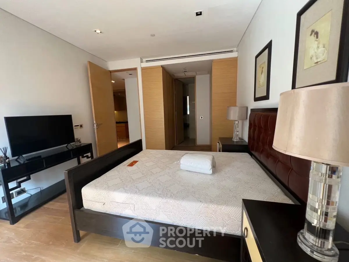 Spacious bedroom with modern decor and ample natural light