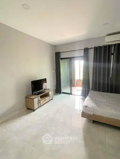 Spacious bedroom with modern decor and natural light