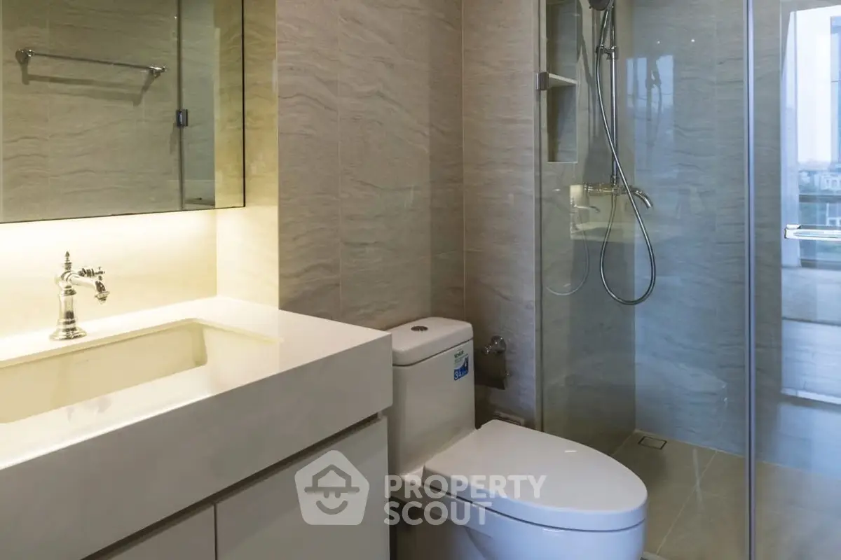 Modern bathroom with sleek fixtures and glass shower enclosure