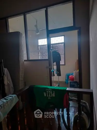 Cozy storage room with natural light and wooden flooring, ideal for organizing personal belongings.