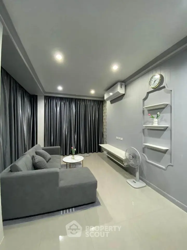 Modern living room with sleek gray sofa and elegant decor