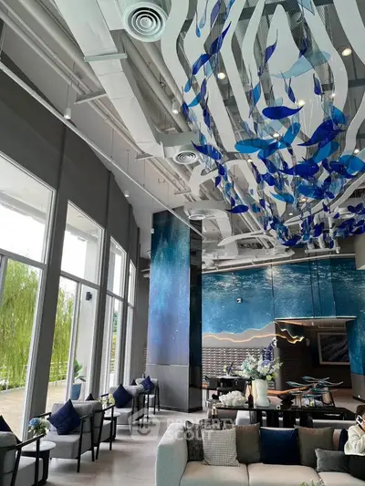 Luxurious modern living room with artistic ceiling and large windows