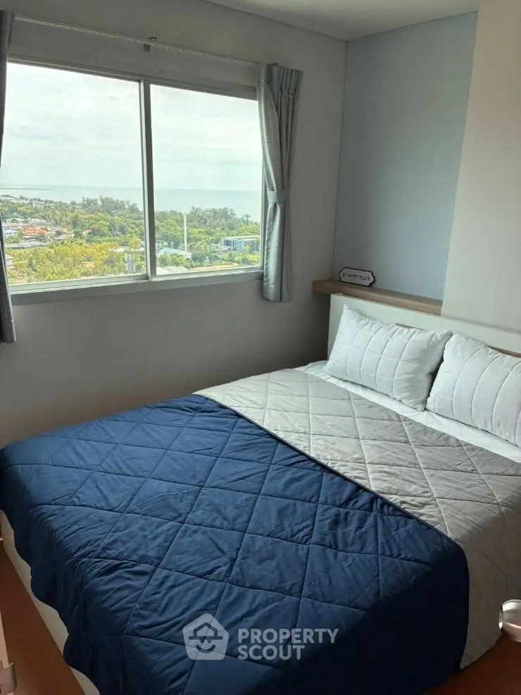 Cozy bedroom with scenic window view and modern decor