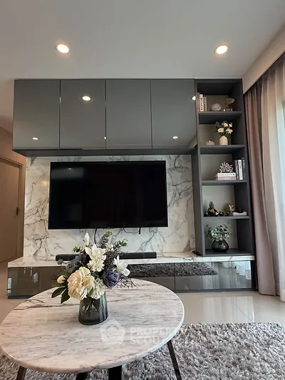 Modern living room with sleek TV unit and marble accents