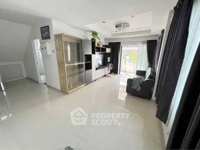 Spacious modern living room with sleek furniture and large windows for natural light.