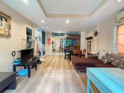 Spacious living room with modern decor and ample natural light