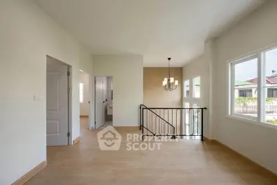Spacious modern interior with wooden flooring and large windows, perfect for natural light.