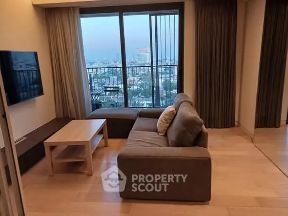 Modern living room with city view, featuring cozy sofa and sleek wooden flooring.