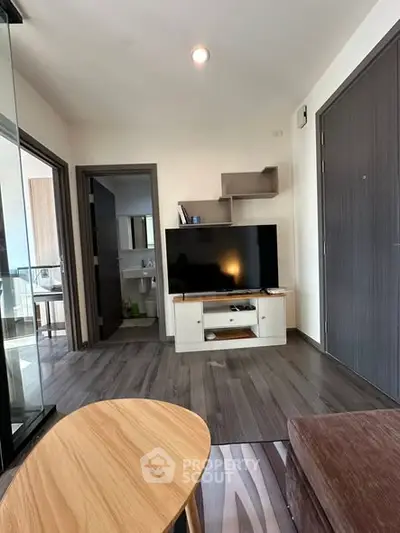 Modern living room with sleek TV setup and stylish wooden flooring