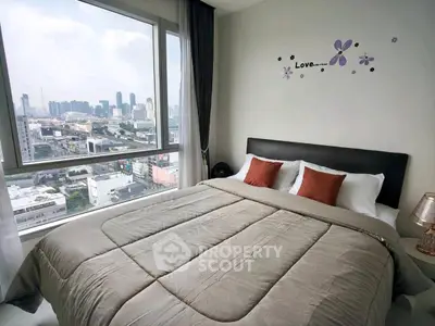 Luxurious bedroom with stunning city view and elegant decor in modern high-rise apartment.