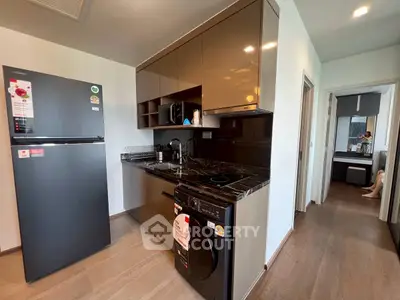Modern kitchen with sleek cabinetry and built-in appliances in a stylish apartment.