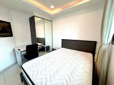 Modern bedroom with sleek design, featuring a comfortable bed and mirrored wardrobe, perfect for urban living.