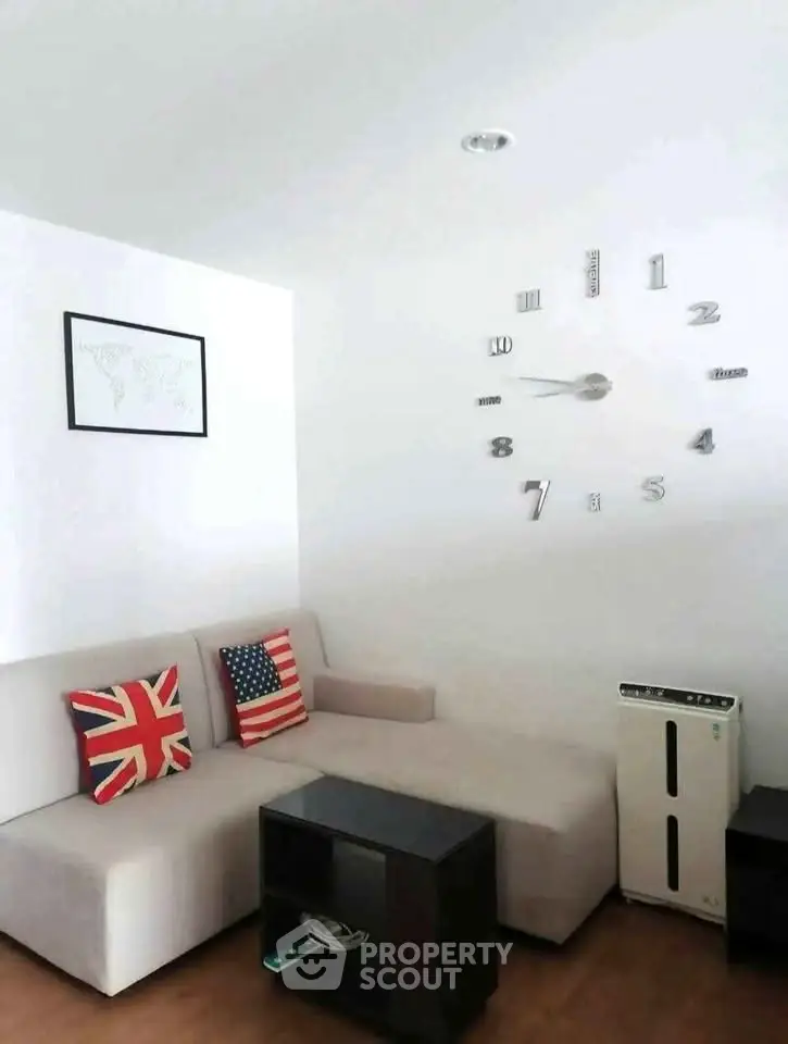 Modern living room with stylish wall clock and cozy sectional sofa