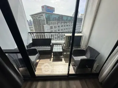 Chic urban balcony with modern seating and city view, perfect for relaxation and entertainment.