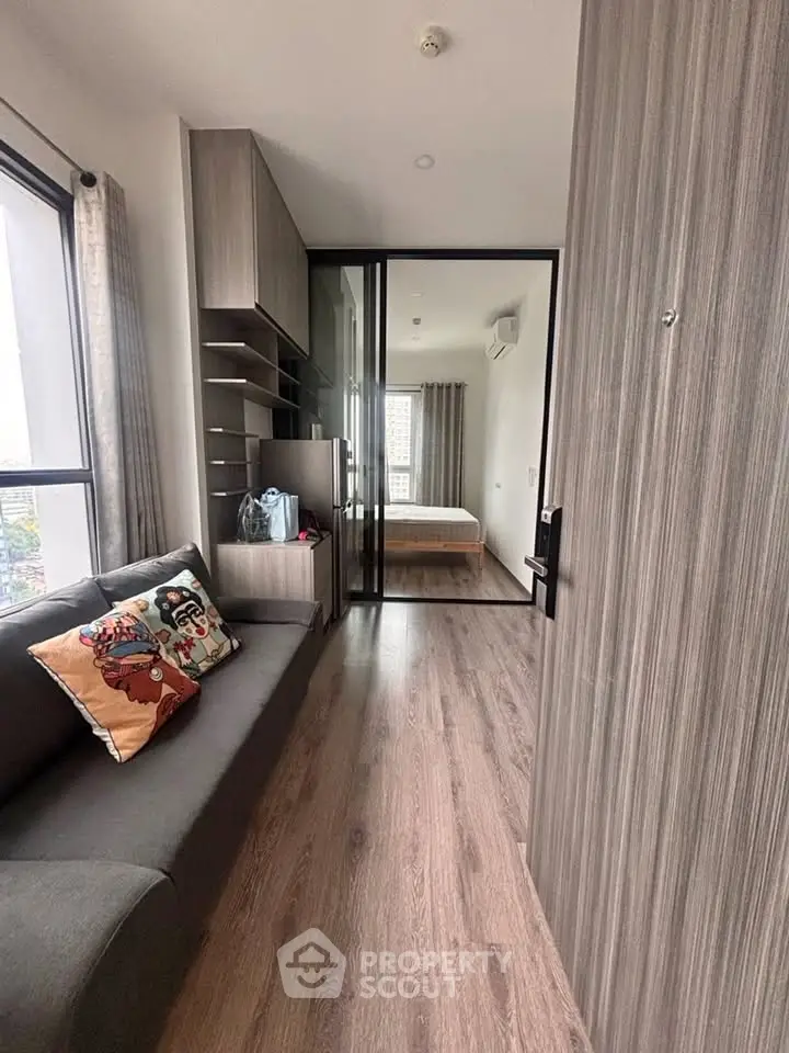 Modern apartment interior with cozy living area and stylish bedroom view.