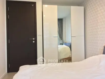 Modern bedroom with sleek wardrobe and cozy bed in stylish apartment.