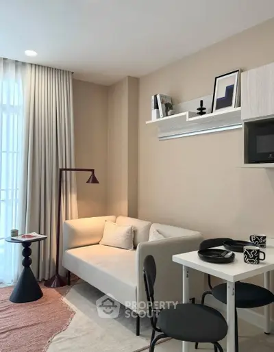 Modern living room with cozy sofa, stylish decor, and natural light.