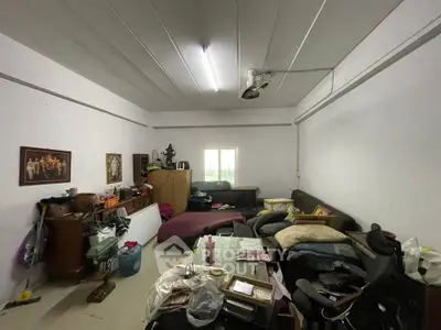 Spacious room with potential for renovation, featuring ample natural light and versatile layout.