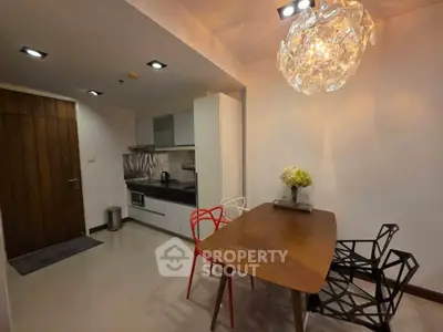 Modern kitchen with stylish dining area and unique lighting fixture