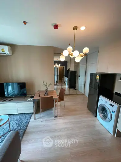 Modern living room with stylish furniture and appliances in a cozy apartment setting.