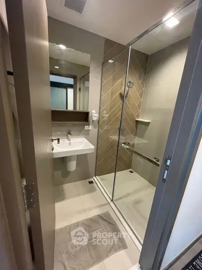 Modern bathroom with glass shower and sleek sink design