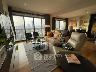 Spacious modern living room with city view, stylish furniture, and natural light.