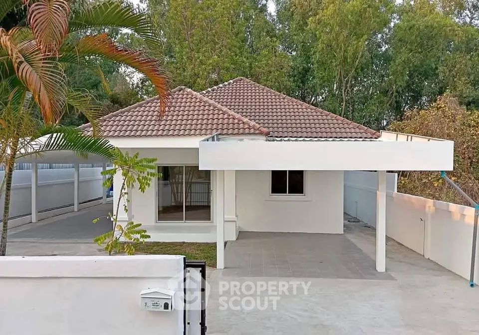 Charming single-story house with tiled roof and spacious driveway in serene neighborhood.