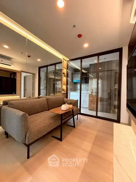Modern living room with glass partition and stylish furniture in a cozy apartment.