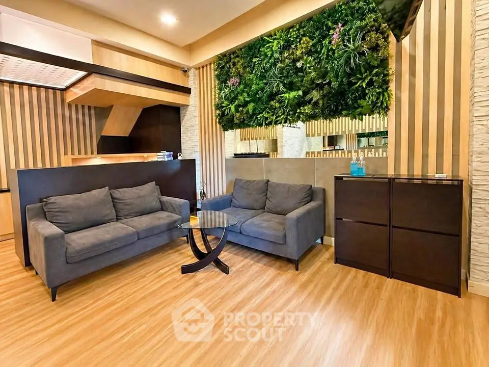 Modern living room with stylish decor and vertical garden wall