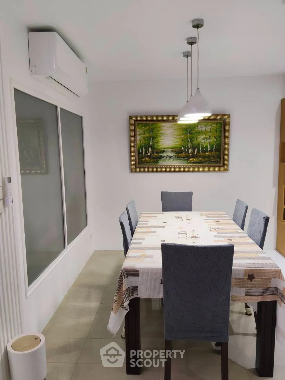Elegant dining room with modern decor and stylish lighting, perfect for family gatherings.