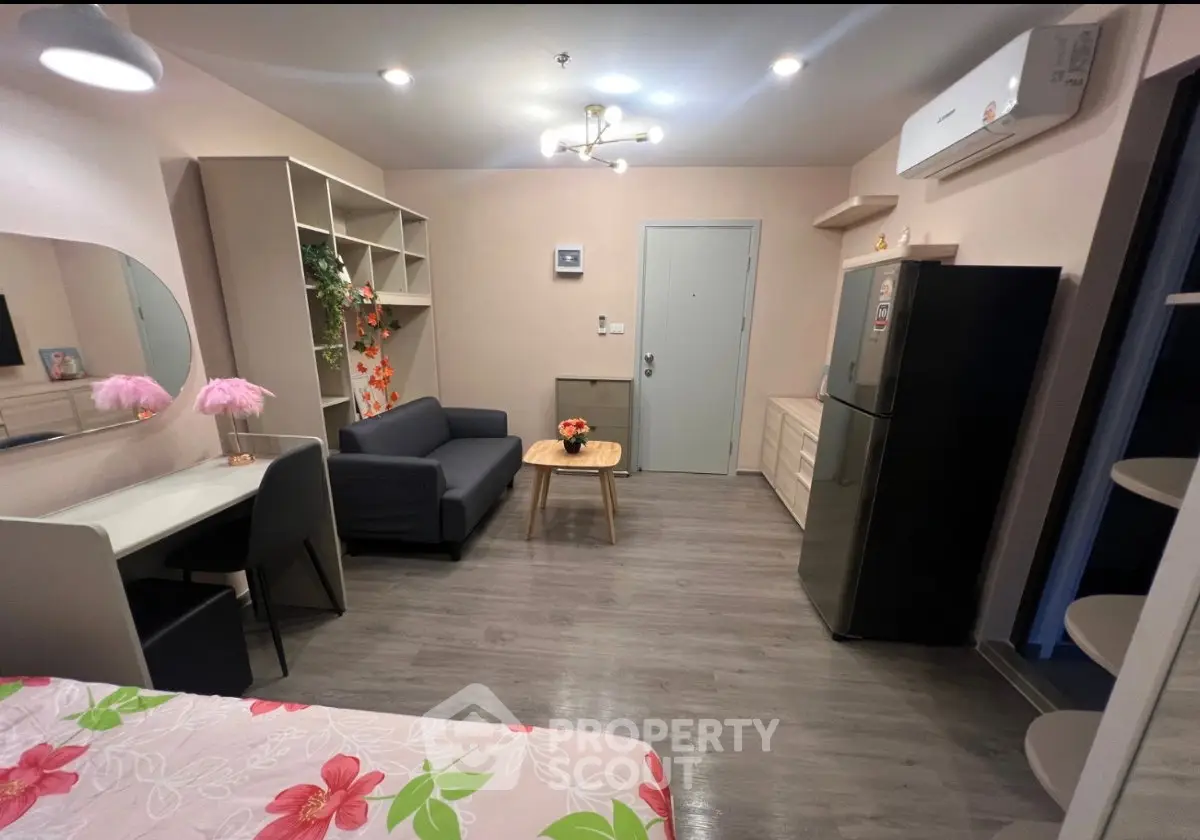 Modern studio apartment with stylish decor and open layout, featuring cozy living area and compact kitchen.
