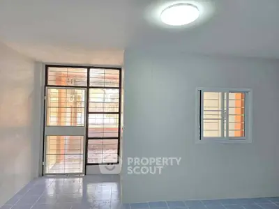 Spacious interior with large windows and modern lighting, perfect for natural light lovers.