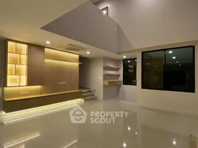 Spacious modern living room with elegant lighting and sleek design.