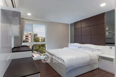 Modern bedroom with large window and stylish decor in urban apartment