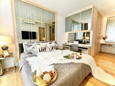 Luxurious modern bedroom with stylish decor and mirrored accents