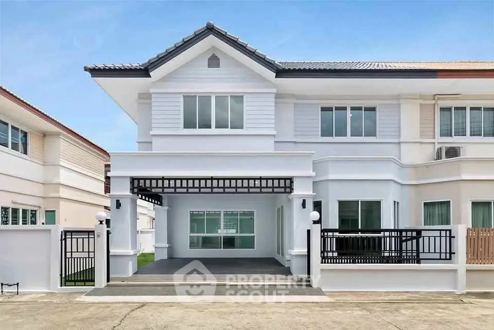 Elegant two-story house with modern facade and spacious driveway in suburban neighborhood.