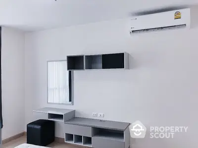 Sleek minimalist living room with modern air conditioning unit and stylish modular shelving, perfect for urban living.