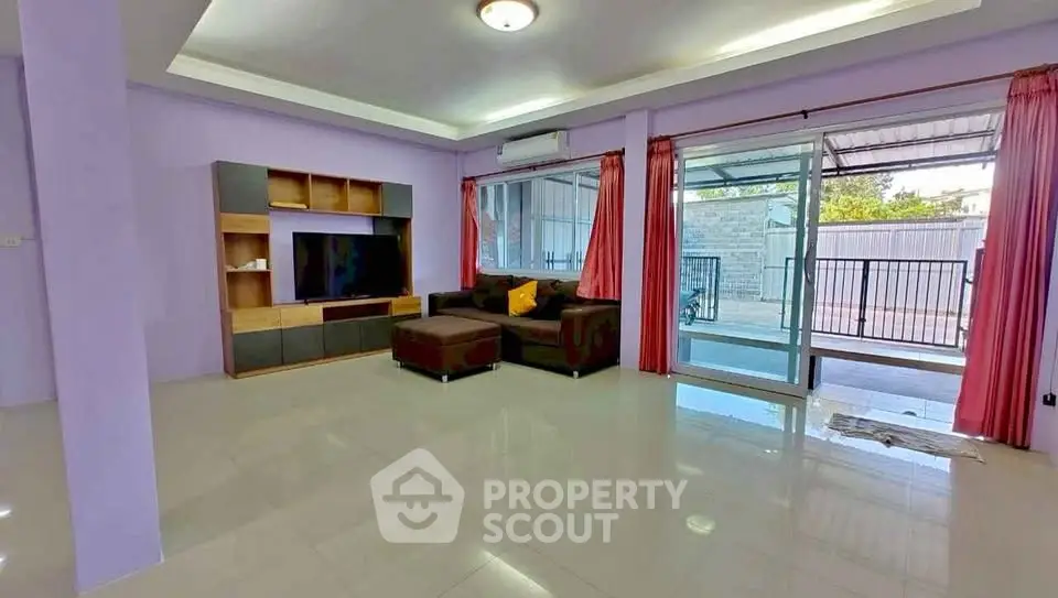 Spacious living room with modern decor and large windows for natural light.