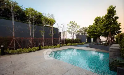 Luxurious outdoor pool area with lush greenery and modern design
